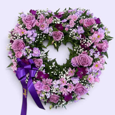 Heart-shaped floral wreath with lavender roses and purple ribbon
