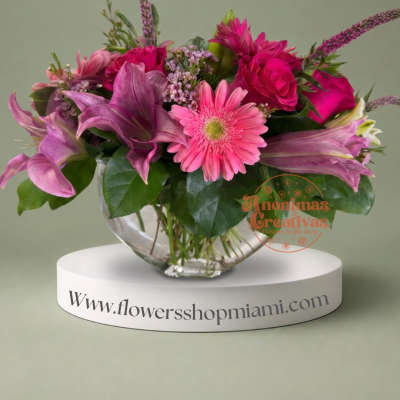 Pink and purple mixed bouquet in a clear glass bowl vase