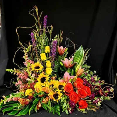 Colorful mixed floral arrangement with sunflowers, roses, and lilies