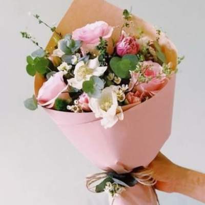 Pink and white bouquet wrapped in pastel paper
