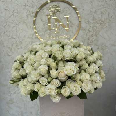 Large bouquet of white roses in a pale pink hat box