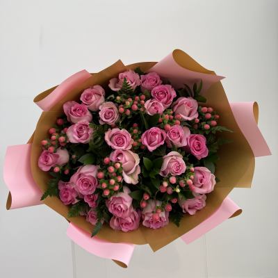 Bouquet of pink roses wrapped in brown and pink paper