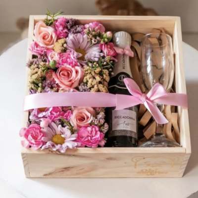 Pink floral gift box with a champagne bottle and two glasses
