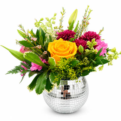 Mixed bouquet with a yellow rose in a mirrored vase
