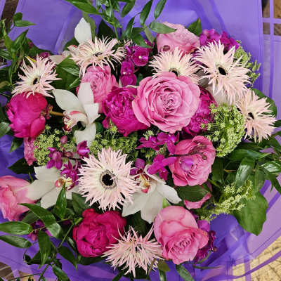 Pink and white mixed bouquet wrapped in purple paper