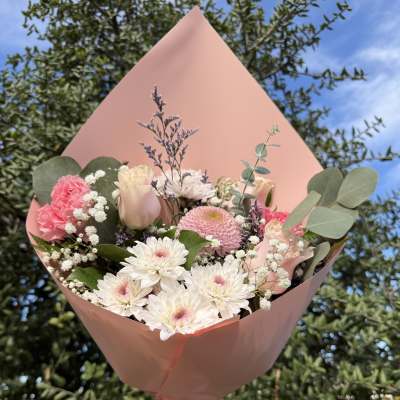 Pink and white bouquet wrapped in blush paper