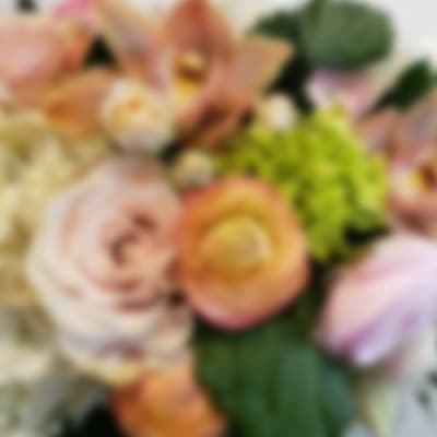 Blurred bouquet of pastel flowers with peach and pink blooms
