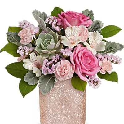 Short arrangement of pink roses, carnations, and a green succulent in a glittery pink vase