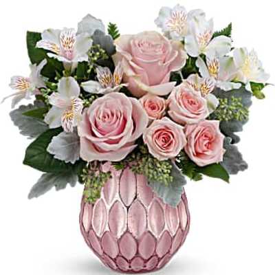 Pink roses and white alstroemeria arranged in a pink textured glass vase