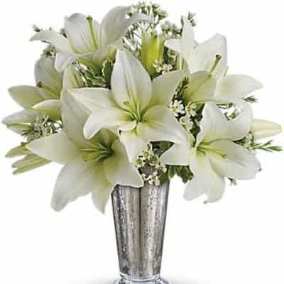 White lilies arranged in a silver metallic vase