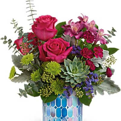 Bright pink roses, green mums, and a succulent arranged in a blue mosaic vase.