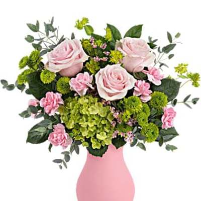 Pink and green bouquet with roses, hydrangea, and button mums in a matte pink vase