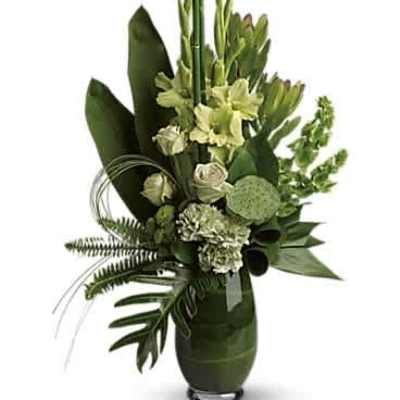Tall green and white floral arrangement with lilies and roses in a green glass vase