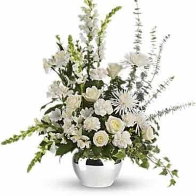Tall all-white floral arrangement with roses, carnations, mums and snapdragons in a round silver vase