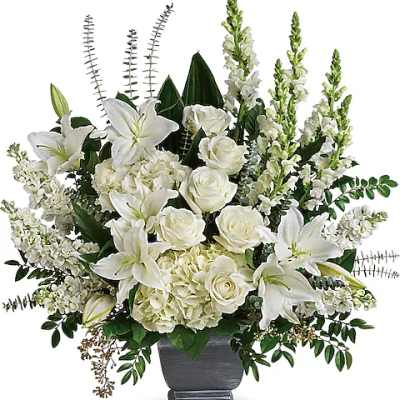 White lilies and roses arranged in a dark vase