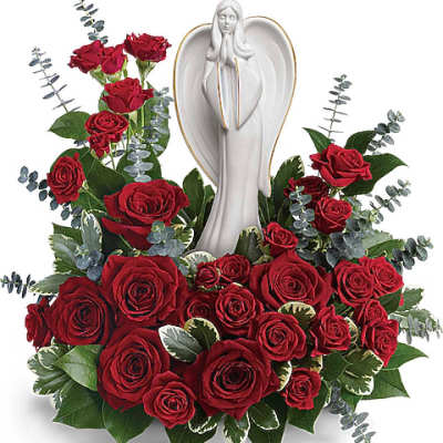 Red roses arranged around a white angel statue