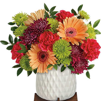 Mixed bouquet of gerbera daisies and chrysanthemums in a white vase