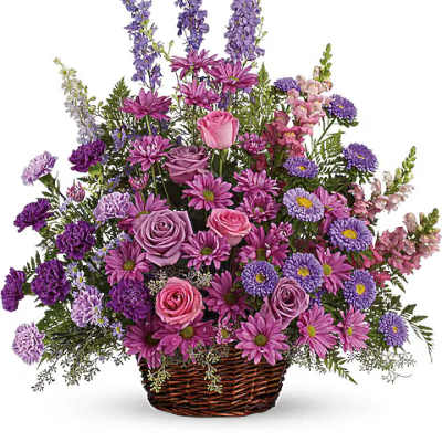 Basket arrangement of purple and pink flowers with tall spikes