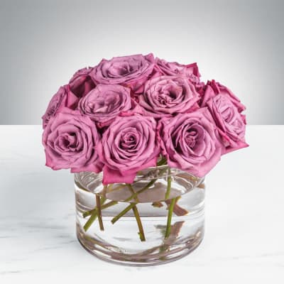 Pink roses arranged in a clear glass vase
