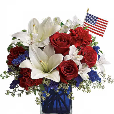 Red roses and white lilies in a blue glass vase with a small American flag