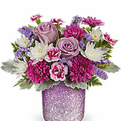 Bouquet of pink and lavender flowers in a glittery purple vase