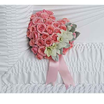 Pink rose bouquet with pale flowers and a pink ribbon on white fabric
