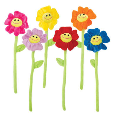 Colorful plush smiling flowers with long green stems on a white background