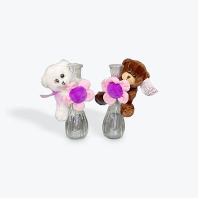 Two teddy bears holding pink and purple flowers in glass vases