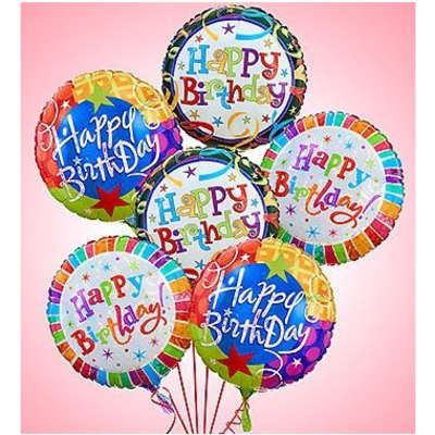 Cluster of colorful birthday balloons on a pink background
