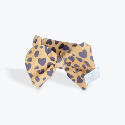 Leopard-print fabric bow with dark heart shapes