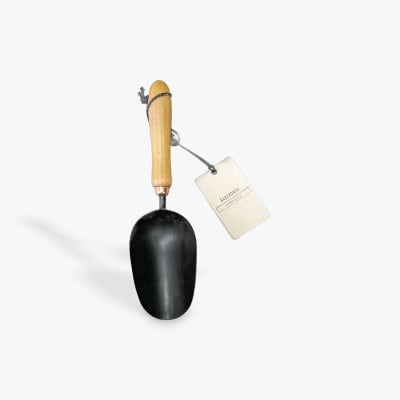Black metal garden scoop with a wooden handle and hanging tag