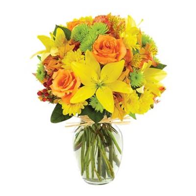 Yellow and orange flower bouquet in a clear glass vase