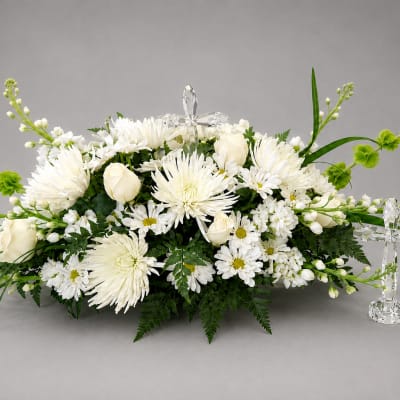 White floral arrangement with roses and chrysanthemums, accented by crystal crosses
