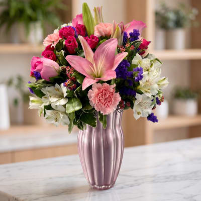 Pink and white mixed bouquet in a pink glass vase