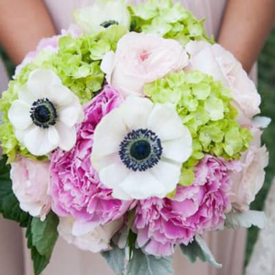 Wedding bouquet with white anemones, pink peonies, and green hydrangeas