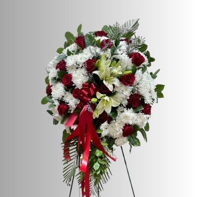 Standing floral spray with red roses, white chrysanthemums, and lilies