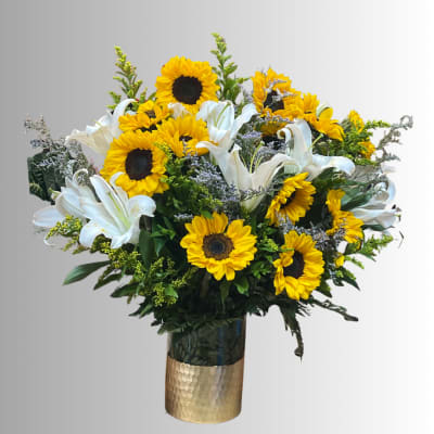 Bouquet of sunflowers and white lilies in a gold vase