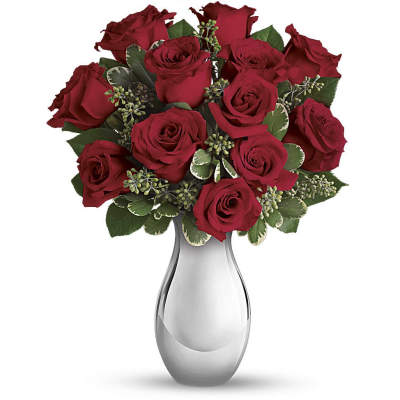 Arrangement of red roses in a shiny silver vase