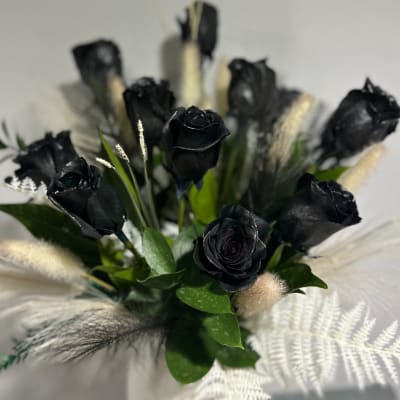 Bouquet of black roses with white dried accents