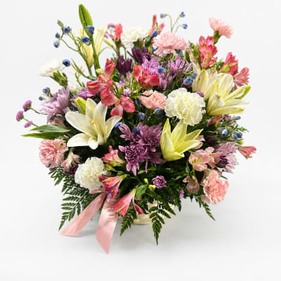 Mixed bouquet of lilies, carnations, and chrysanthemums in a vase