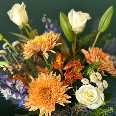 Mixed bouquet with orange chrysanthemums, white roses, and white lilies