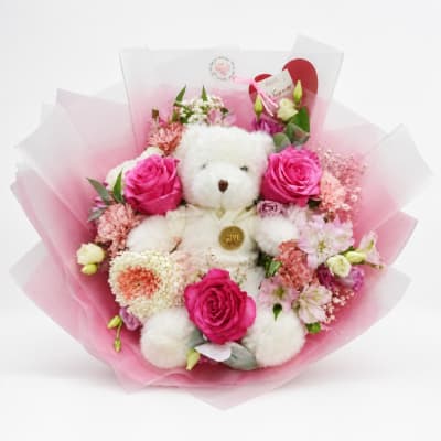 Pink rose bouquet with a white teddy bear in pink wrapping