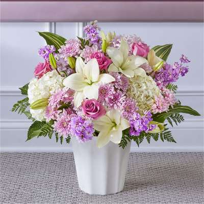 Pink and white floral arrangement in a white vase