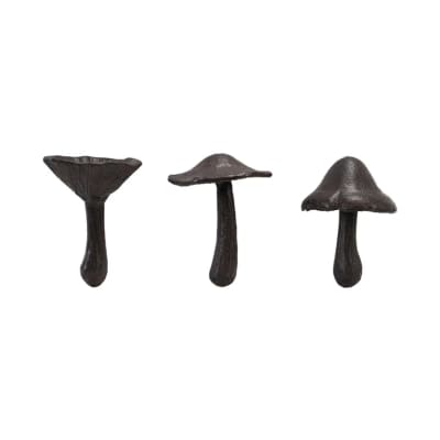 Three dark mushroom-shaped decorative objects on a white background