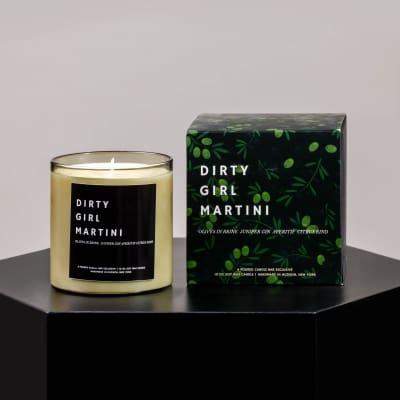 Scented candle in a glass jar beside its matching box
