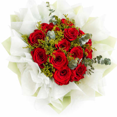 Bouquet of red roses wrapped in white paper