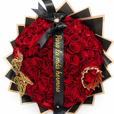 Heart-shaped bouquet of red roses with a black ribbon and gold accents