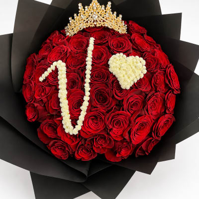 Red rose bouquet with a gold crown and white floral lettering