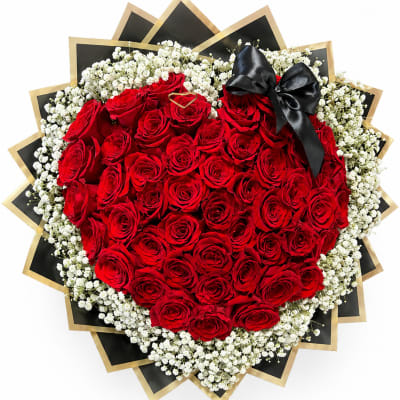 Heart-shaped bouquet of red roses with white baby's breath and a black ribbon