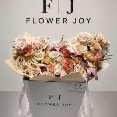 Bouquet of blush and cream roses in a white gift box